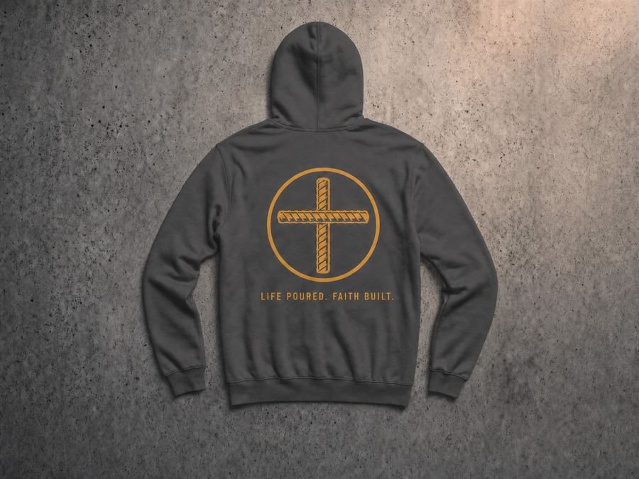 Charcoal-gray pullover hoodie, back view, with a large gold rebar-cross emblem and the words Life Poured Faith Built centered on the back